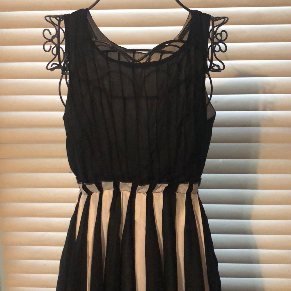 Beautiful black dress with white pleaded accents.